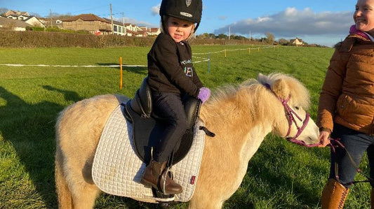 Child riding confidently in a stable children’s saddle suitable for RDA and SEN riders
