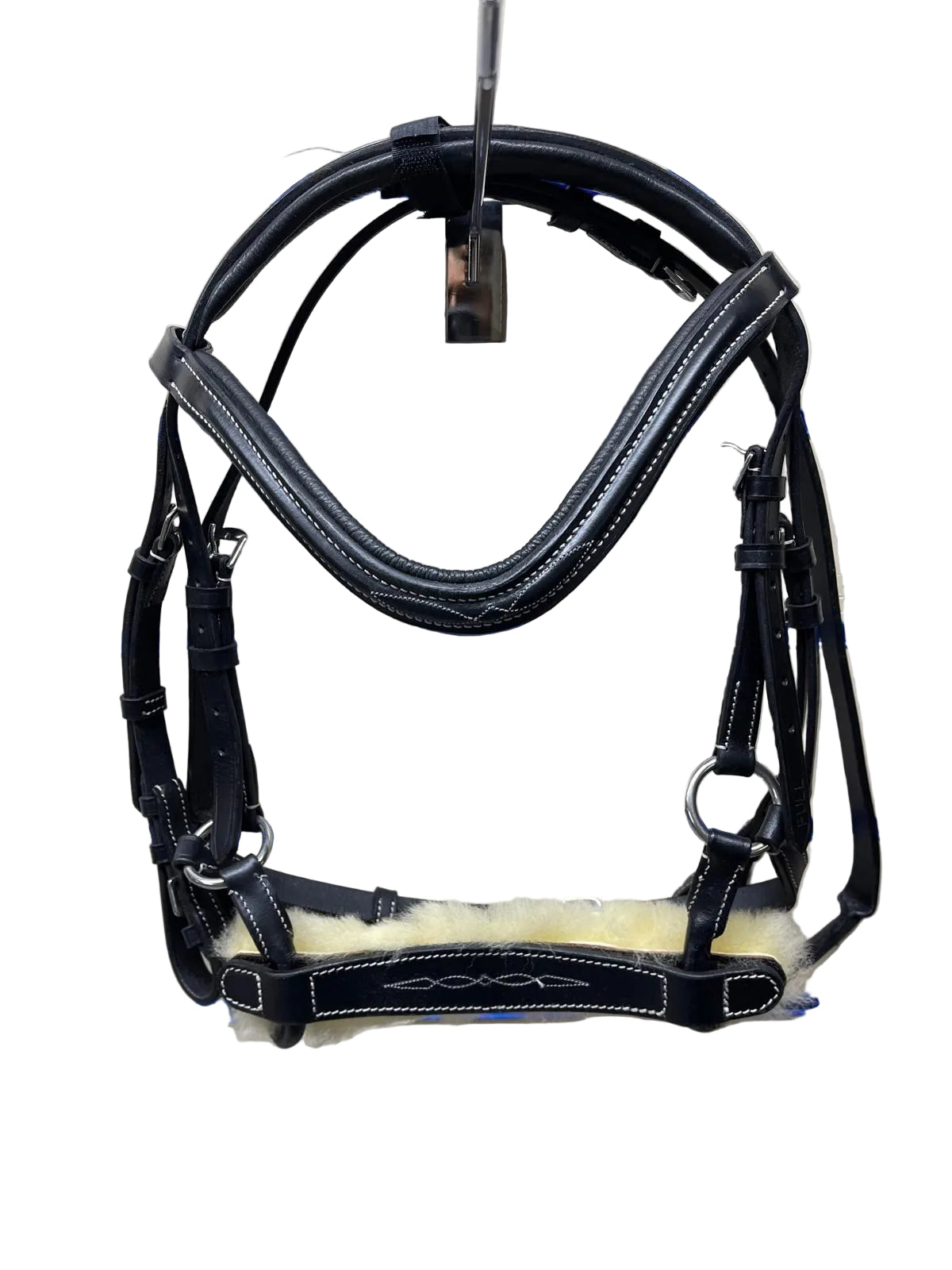 Black leather and shearling horse bridle hanging on a blue-striped wall display.