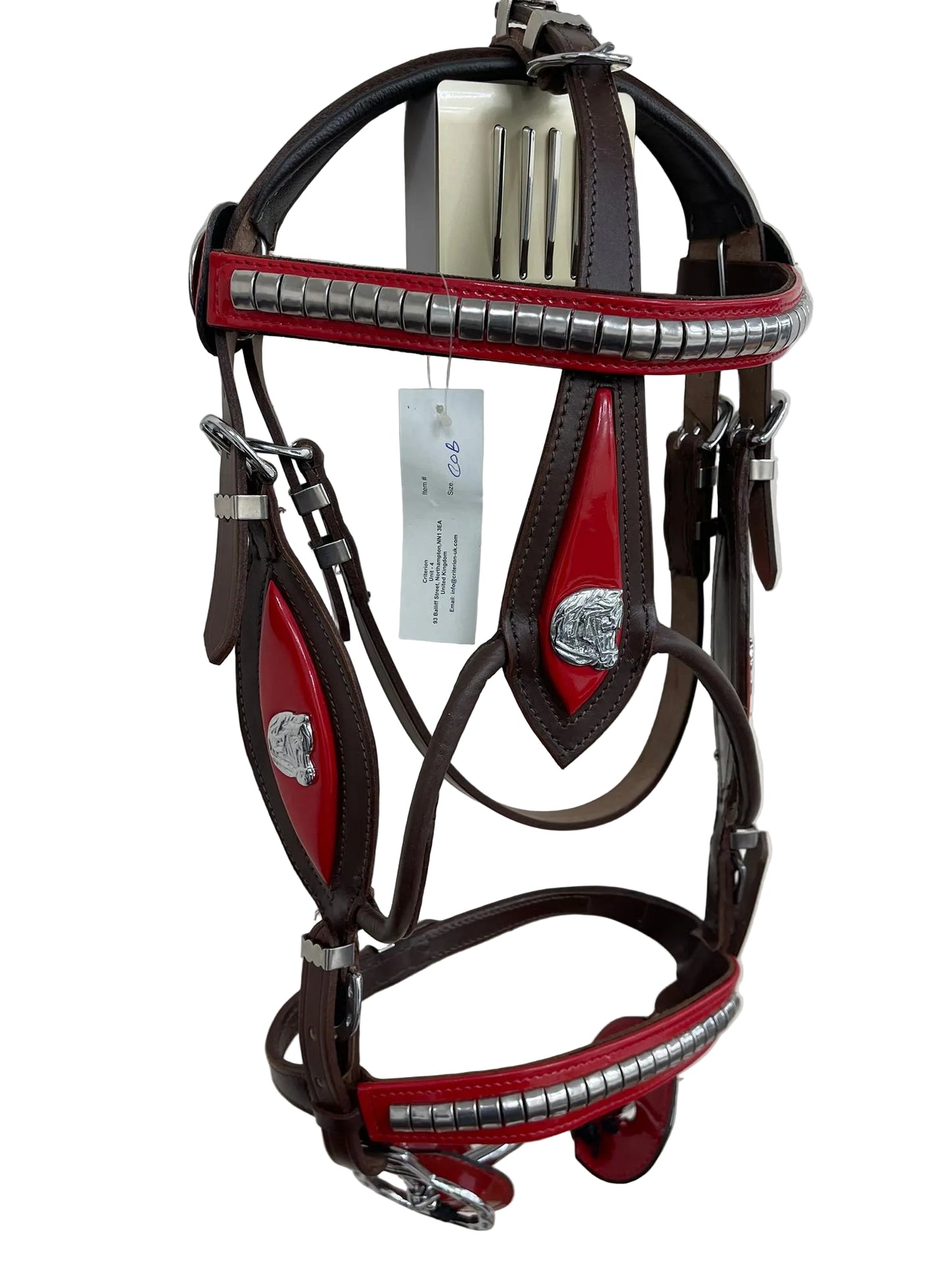 Brown and red horse bridle with silver accents on a white background