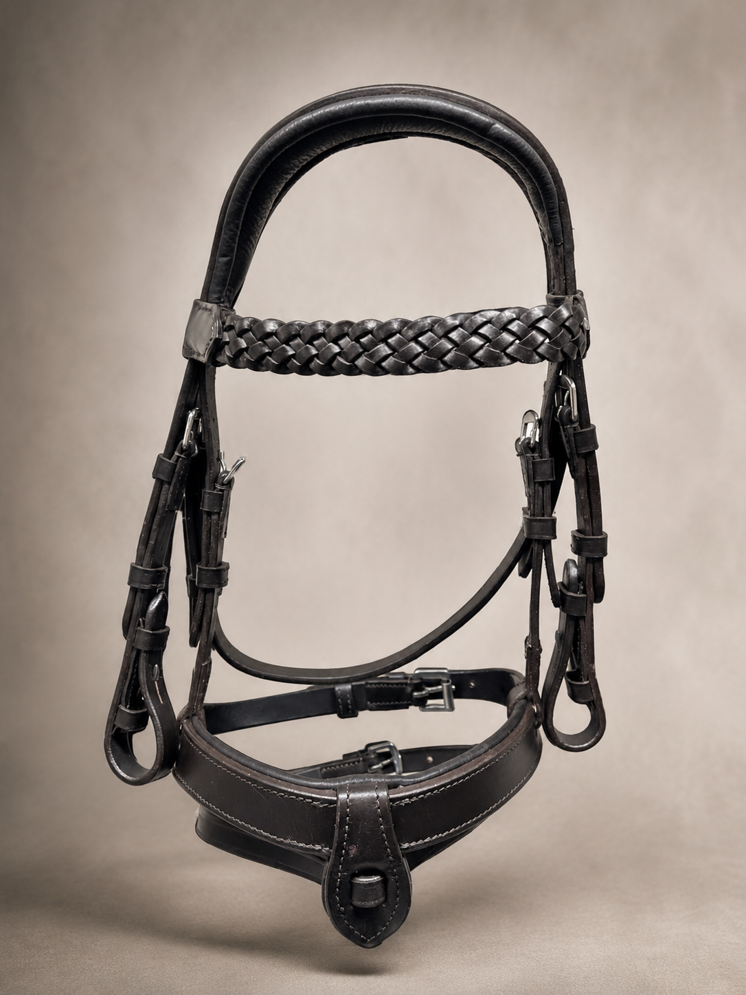 Black leather horse bridle with braided browband and padded noseband